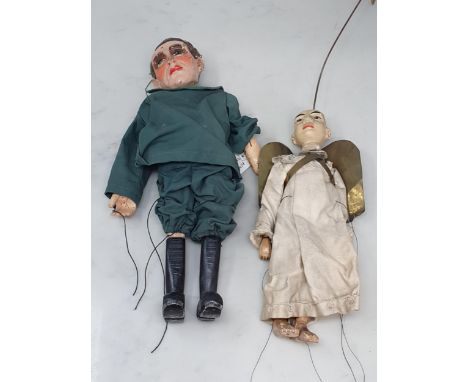 An antique Puppet in the form of a man with plaster head painted with hair and facial details and connected to a wooden retic