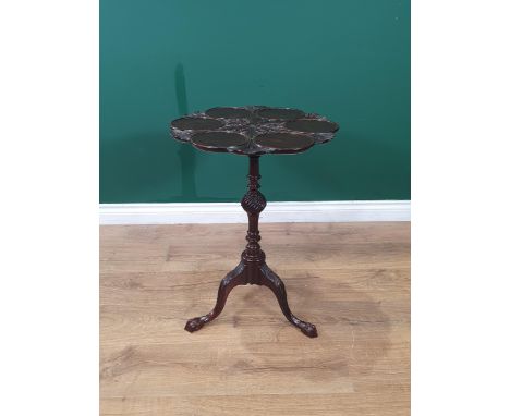 A Georgian mahogany Table, the shaped top with six dished sections, carved leafage and rosette design on turned and fluted co
