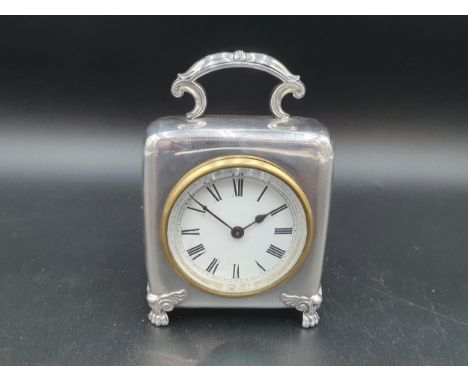 A Victorian silver cased Dressing Table Clock with white enamel circular dial on shaped supports with paw feet, Birmingham 19