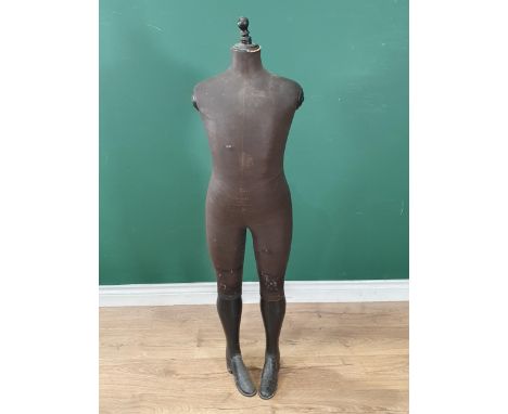 An antique Dressmaker's Mannequin with hard fabric covered body and wooden lower legs and boots, stamped Stockman of Paris to
