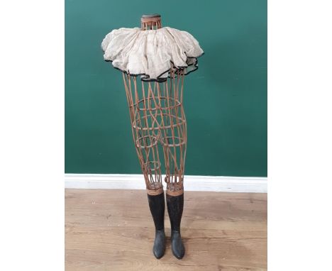 An antique child size Dressmaker's Mannequin with open wicker body and wooden lower legs and boots (woodworm) A/F 3ft 6in H 