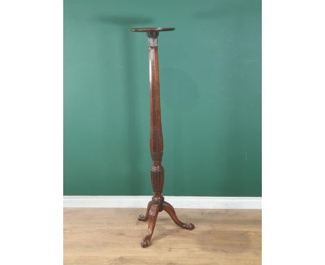 A mahogany Torchere Stand with dished top on octagonal baluster tapering column and carved tripod base, 4ft 10in H 