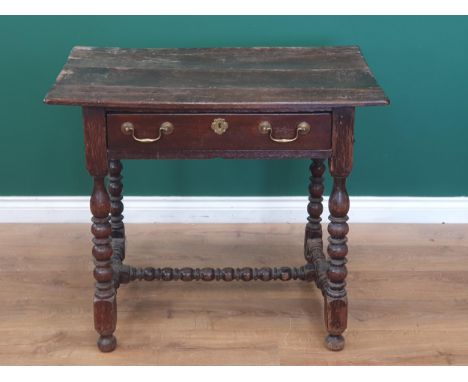 A late 17th Century oak Side Table with three plank top above single frieze drawer with later handles on bobbin and fillet tu