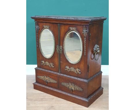 An oak table top Cabinet with pair of doors set oval mirror panels, above two drawers, 1ft 11in H x 1ft 8in W 