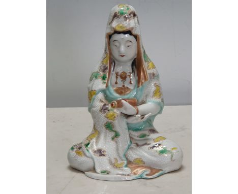 A Chinese seated Figure holding a scroll, with coloured enamel decoration, 7in H 