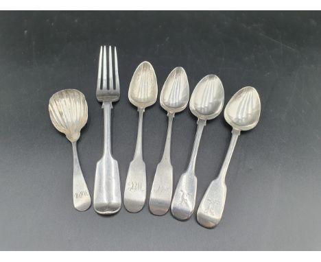 An Irish silver Caddy Spoon with scallop bowl engraved initials,  a silver Fork and three Teaspoons fiddle pattern 