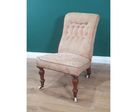A Victorian upholstered button back Slipper Chair with floral decoration, raised on turned walnut front supports and brass an