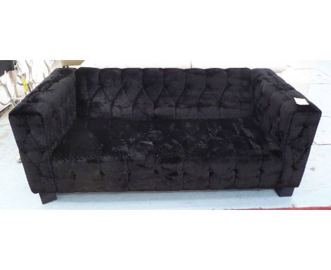 SOFA, two seater, in black buttoned fabric on square supports, 183cm L.