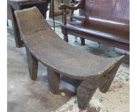 PYGMY BENCH, West African, carved wood with brass studding, 114cm L.
