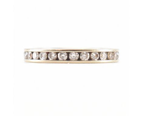 A hallmarked 18ct white gold and diamond eternity ring. The ring being channel set with round cut diamonds throughout. Hallma