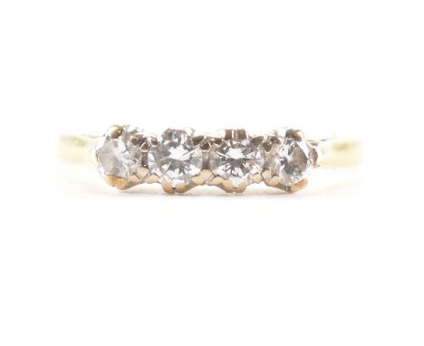 A hallmarked 18ct yellow gold &amp; diamond four stone ring. The ring having four uniform round cut diamonds to pinched cathe