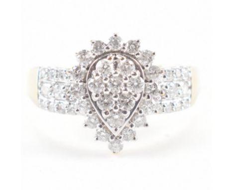 A hallmarked 9ct gold &amp; diamond cluster ring. The ring having a pear shape head set with a cluster of eight round cut dia