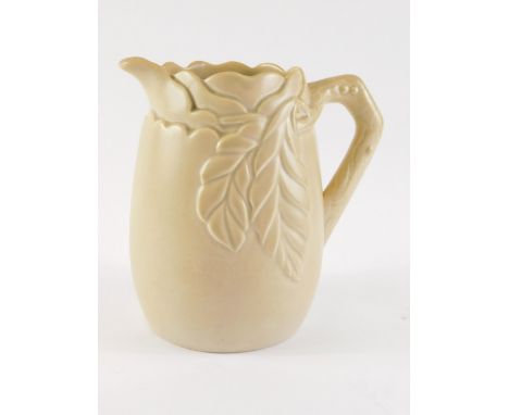 A Clarice Cliff brown glazed relief modelled jug, decorated with leaves and a branch, printed mark to underside, 20cm high.