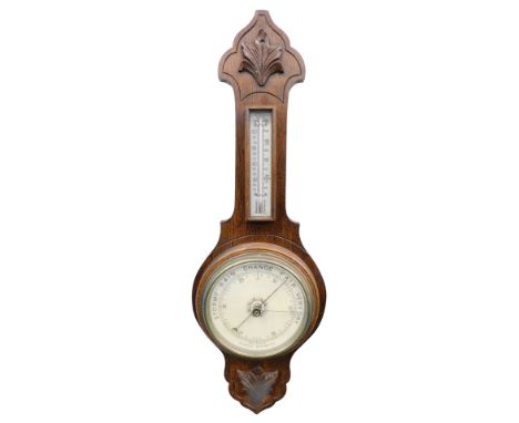 A 20thC oak cased banjo barometer, with raised floral carving above thermometer, 16cm diameter dial, 63cm high.