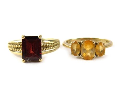 Two 9ct gold dress rings, comprising a citrine three stone ring, ring size S½, and a red paste stone agate cut single stone r