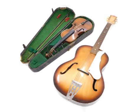 A violin with two piece back, paper label for Stradivarius 1720, maker KS, back 35cm long, and a Prince acoustic guitar, with