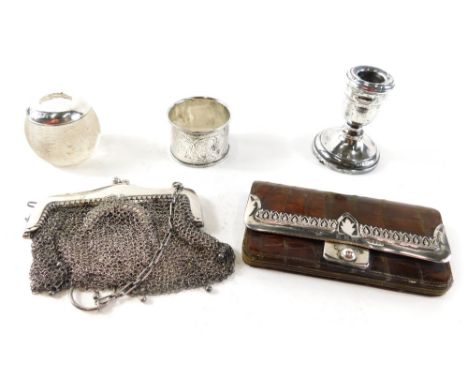 A mid 20thC chain mail evening purse, a crocodile skin finish purse with silver mounts, dwarf candlestick, napkin ring, glass