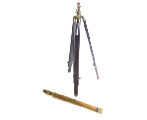 A brass telescope, when closed 77cm long, on a tripod stand with brass fittings.
