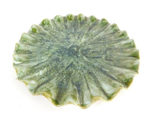 A Linthorpe pottery plate, with flared rim no.471, in green speckled glaze, with tortoise shell glazed verso, impressed marks