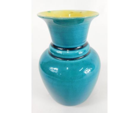 A Linthorpe pottery vase, of shouldered form in turquoise with yellow interior, no. 2208, impressed marks beneath, 12cm high.