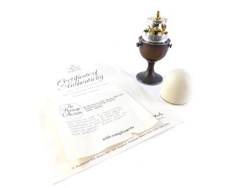 A Elizabeth II novelty silver Surprise Egg, by Anthony Gordon Elson, opening to reveal a miniature carousel egg timer, London