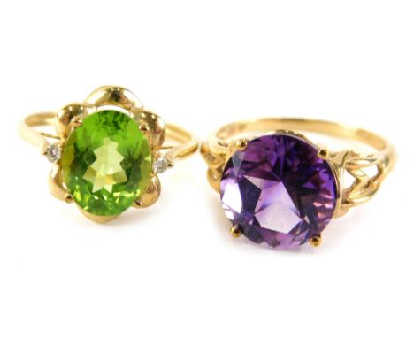 Two 9ct gold dress rings, comprising a peridot and cz set cluster, ring size T, and an amethyst dress ring in basket setting,