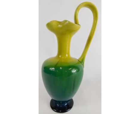 A Linthorpe pottery ewer, in yellow, green and blue decoration with flowerhead stem and angular handle, on circular foot, no.