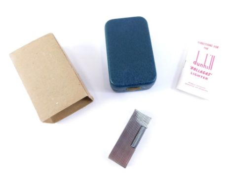 A Dunhill silver plated pocket lighter, the rectangular case with line decoration, 7cm high, in outer case. 