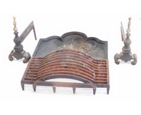 A cast iron and brass fire grate, with turned finials, with an associated grate and a fire back, with a moulded edge and arch