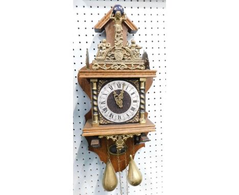 A 20thC oak cased Zaanse Zaandam Dutch pendulum wall clock, shaped arrow back, raised metalwork, 14cm diameter Roman numeric 