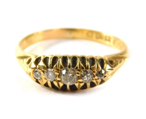 An 18ct gold diamond five stone set dress ring, set with five old cut diamonds, each in a claw setting with scroll design sho