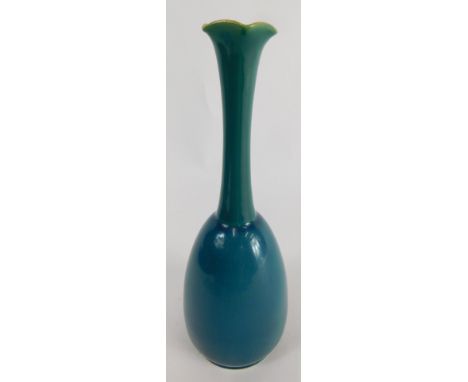 A Linthorpe pottery vase, Christopher Dresser signature mark, with flared stem and shaped body, in turquoise, on circular foo