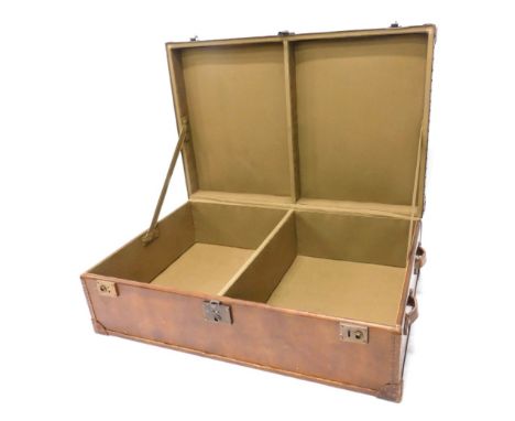 A large oversized brown leather travel trunk or coffee table, with two side handles to each end, 39cm high, 122cm wide, 79cm 