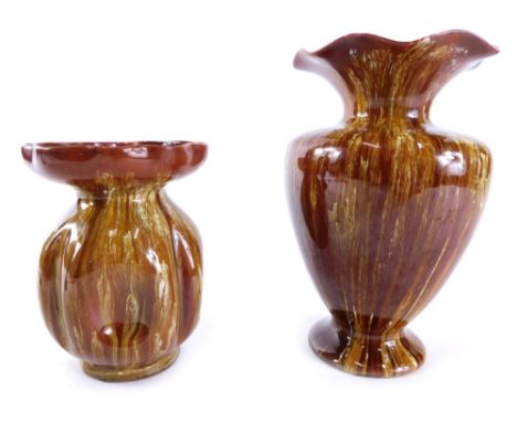 A Linthorpe pottery vase, with floral neck, shouldered body and circular foot, no. 1679, in running glazes of brown and yello