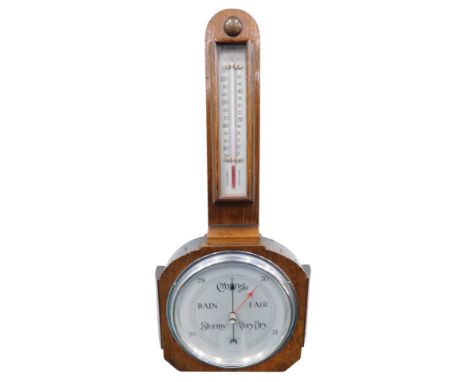 A 1920's oak cased barometer and thermometer, with chrome plated  16cm diameter dial, in shaped case, 54cm high.