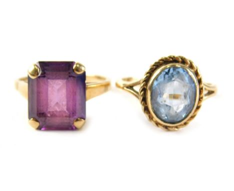 Two 9ct gold dress rings, comprising a aquamarine oval dress ring with rope twist borders, ring size M, and an amethyst ring,