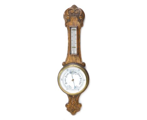 An oak cased barometer, in carved case, with thermometer, 65cm high.