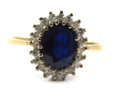 A 9ct gold cluster ring,  set with central oval sapphire, in claw settings, surrounded by tiny diamonds, in a raised basket, 