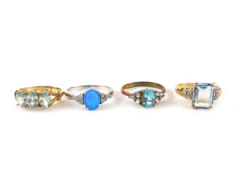 Four dress rings, comprising a 9ct gold aquamarine and cz dress ring, ring size R½, a plated cluster ring, a silver imitation