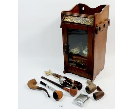 An Edwardian pipe cabinet with tobacco tins, pipes and a Ronson lighter 