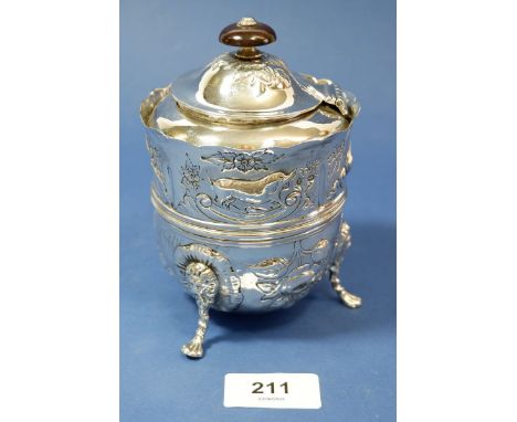 A 19th century silver Irish style tea caddy with embossed dolphin, swan and fox decoration and chased flowers, foliage and re