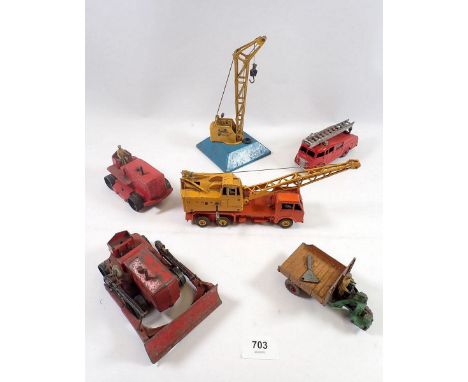 A group of Dinky construction vehicles including cranes, bulldozer, tractor and a fire engine 