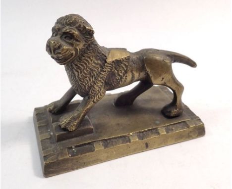 A brass model of a lion with wings clipped, 11 x 6cm 