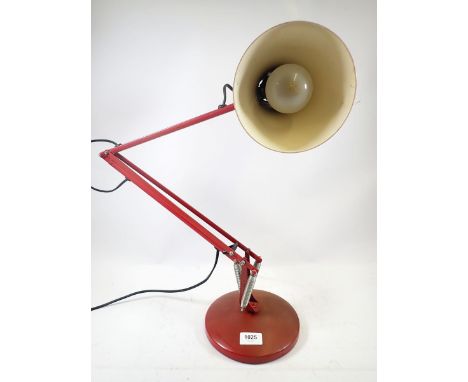 A red anglepoise lamp, model 90 made by the Anglepoise Lighting Co. Ltd 