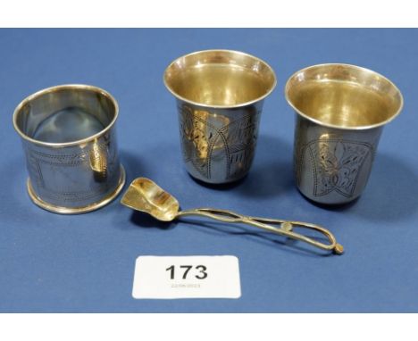 Two Russian silver vodka cups, a similar napkin ring and a silver gilt Russian salt spoon all with 84 Imperial mark, total we