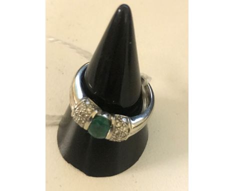 An 18ct emerald and diamond dress ring