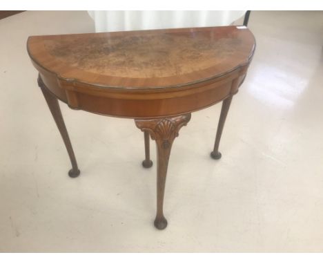 A walnut demi-lune card table