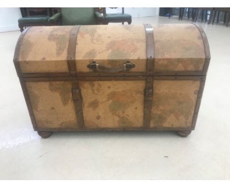 A domed leather-bound trunk decorated with a map of the World