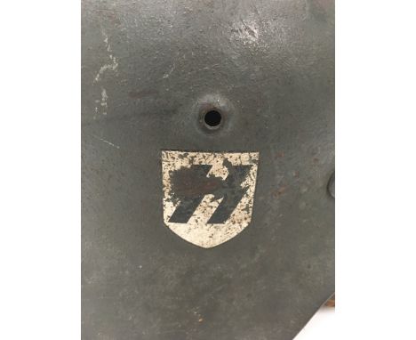 WWII German Double Decal SS Tin Helmet, non folded rim variant, with number 462 to rear below Manufacturers mark "NKQ 64", wi