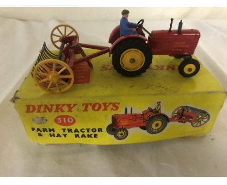 A boxed Dinky No 310 farm tractor and hay rake (tractor and rake mint; box with wear)